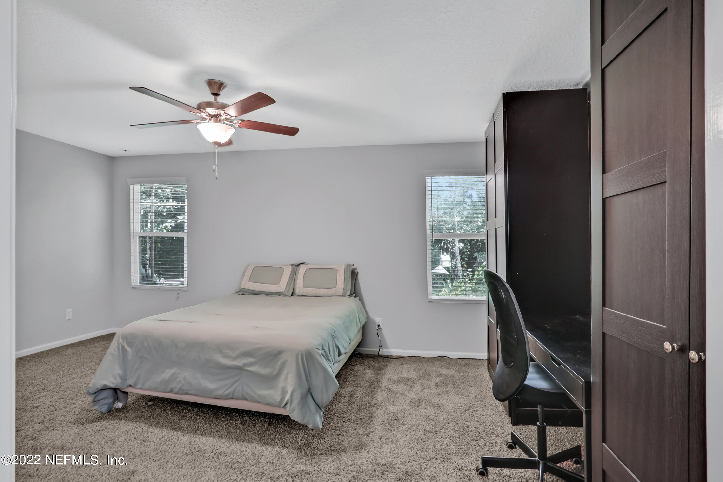 7507 Hilsdale Road Jacksonville, FL 32216 - Photo 19 of 38 a bedroom with a bed and a window