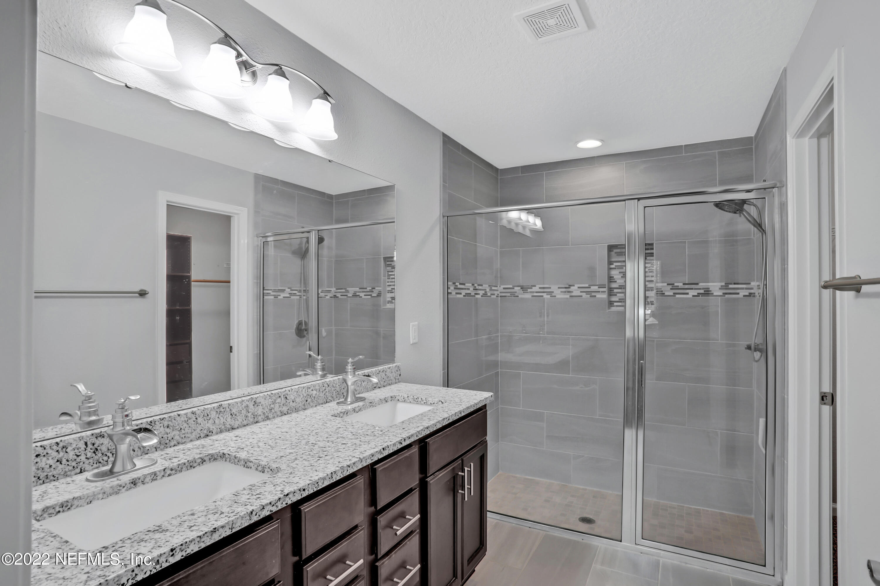 7507 Hilsdale Road Jacksonville, FL 32216 - Photo 21 of 38 a bathroom with a granite countertop shower sink and mirror
