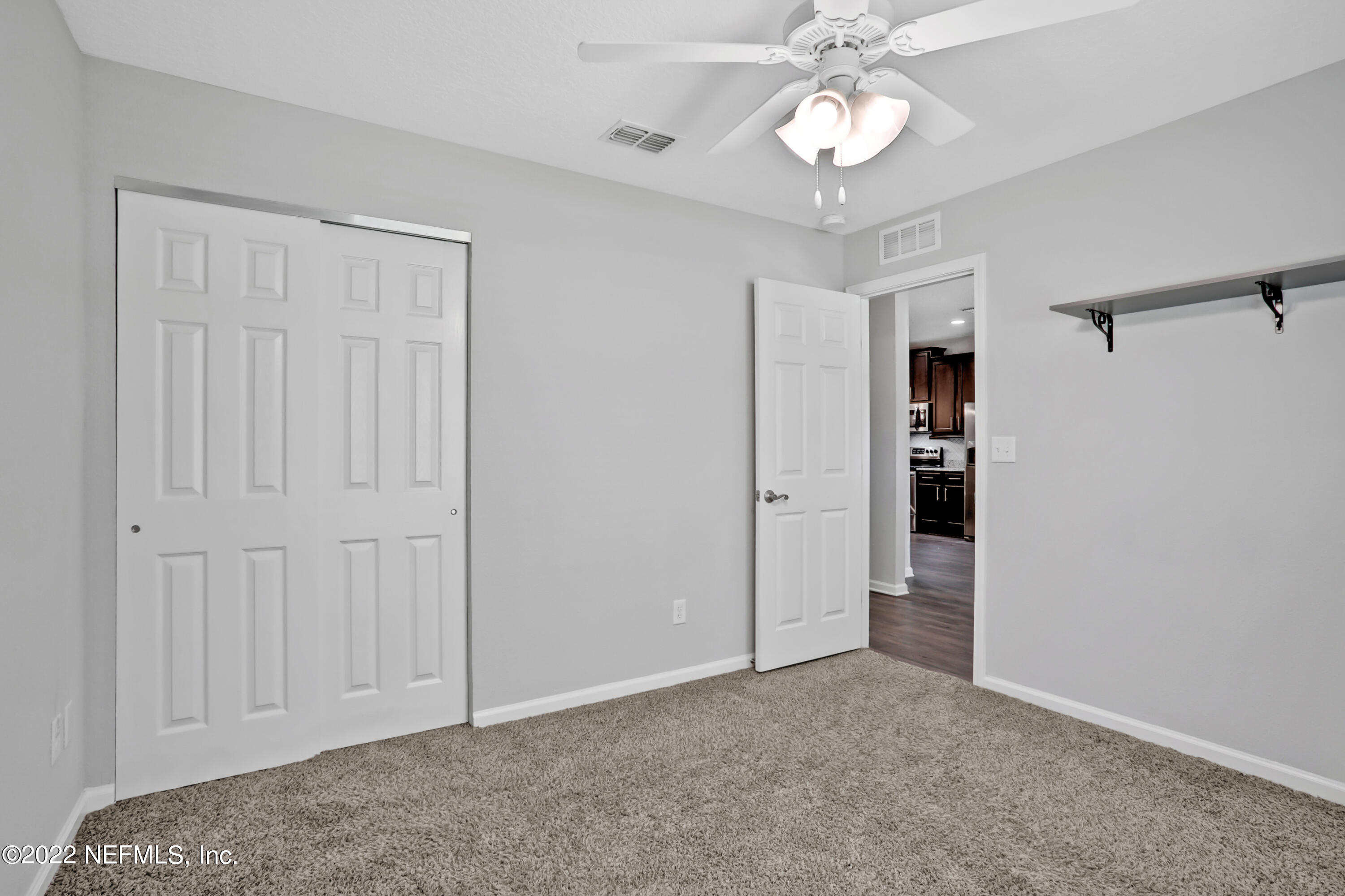 7507 Hilsdale Road Jacksonville, FL 32216 - Photo 24 of 38 a view of an empty room and a ceiling fan
