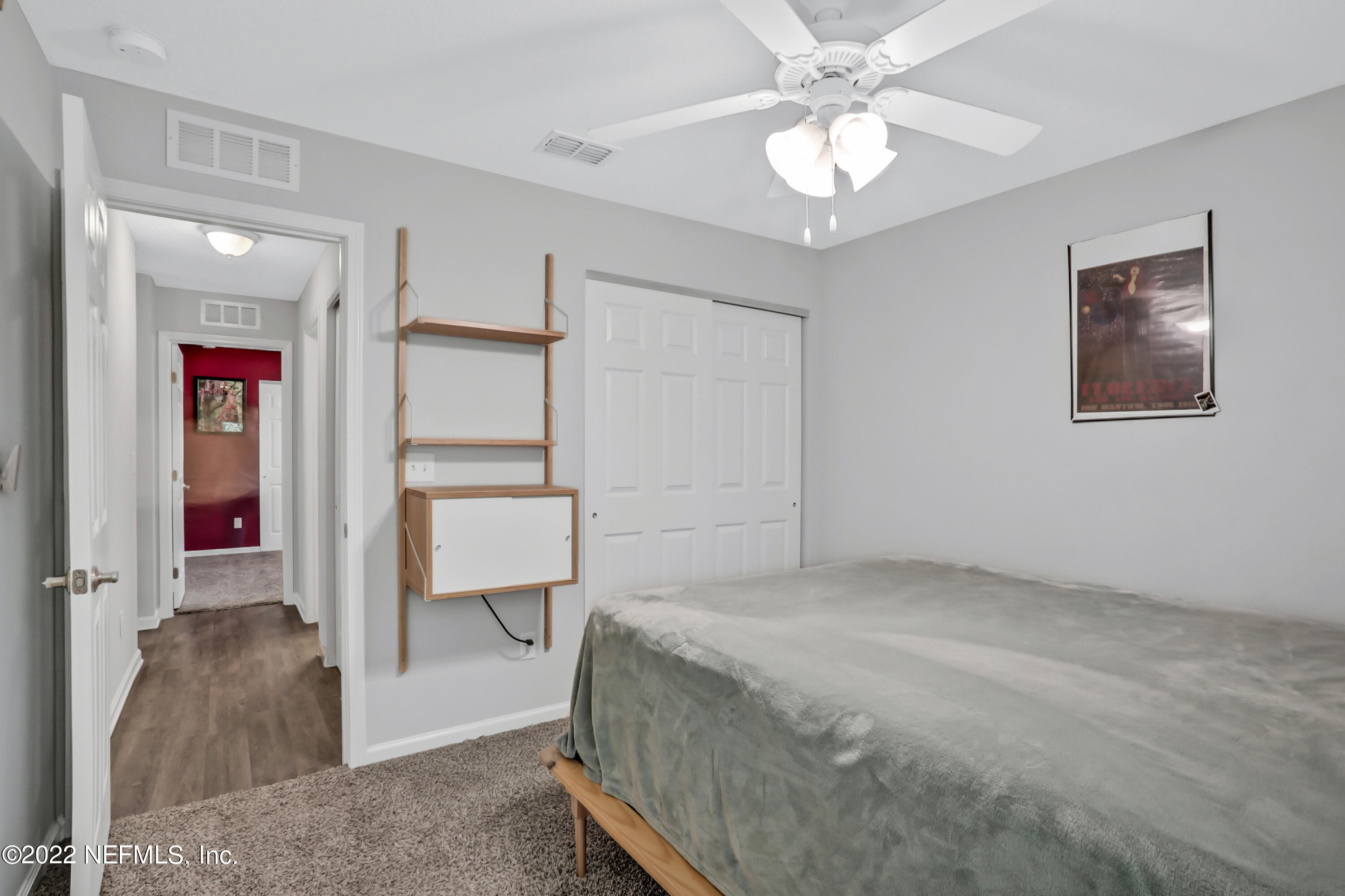 7507 Hilsdale Road Jacksonville, FL 32216 - Photo 26 of 38 a bedroom with a bed and a chandelier
