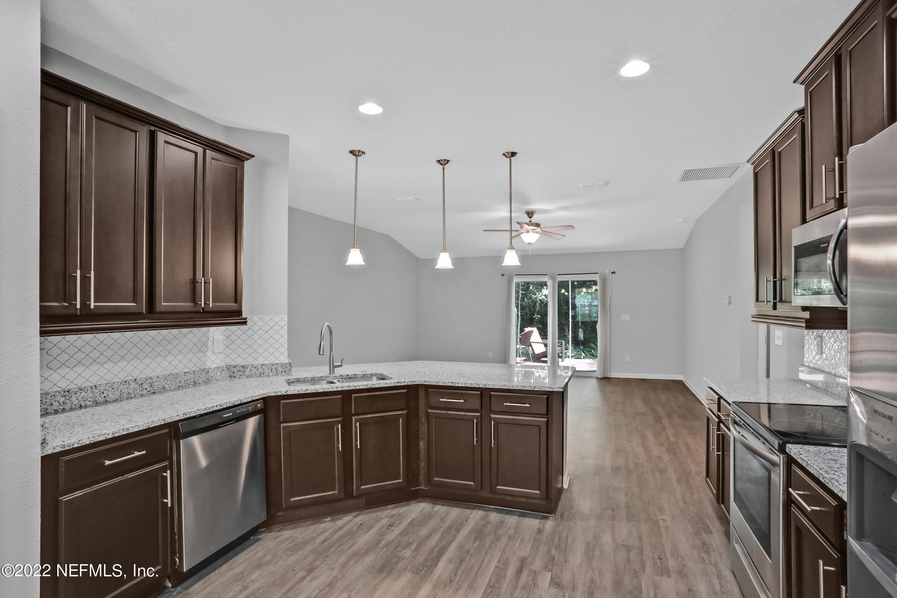 7507 Hilsdale Road Jacksonville, FL 32216 - Photo 8 of 38 a kitchen with a sink stove and wooden cabinets