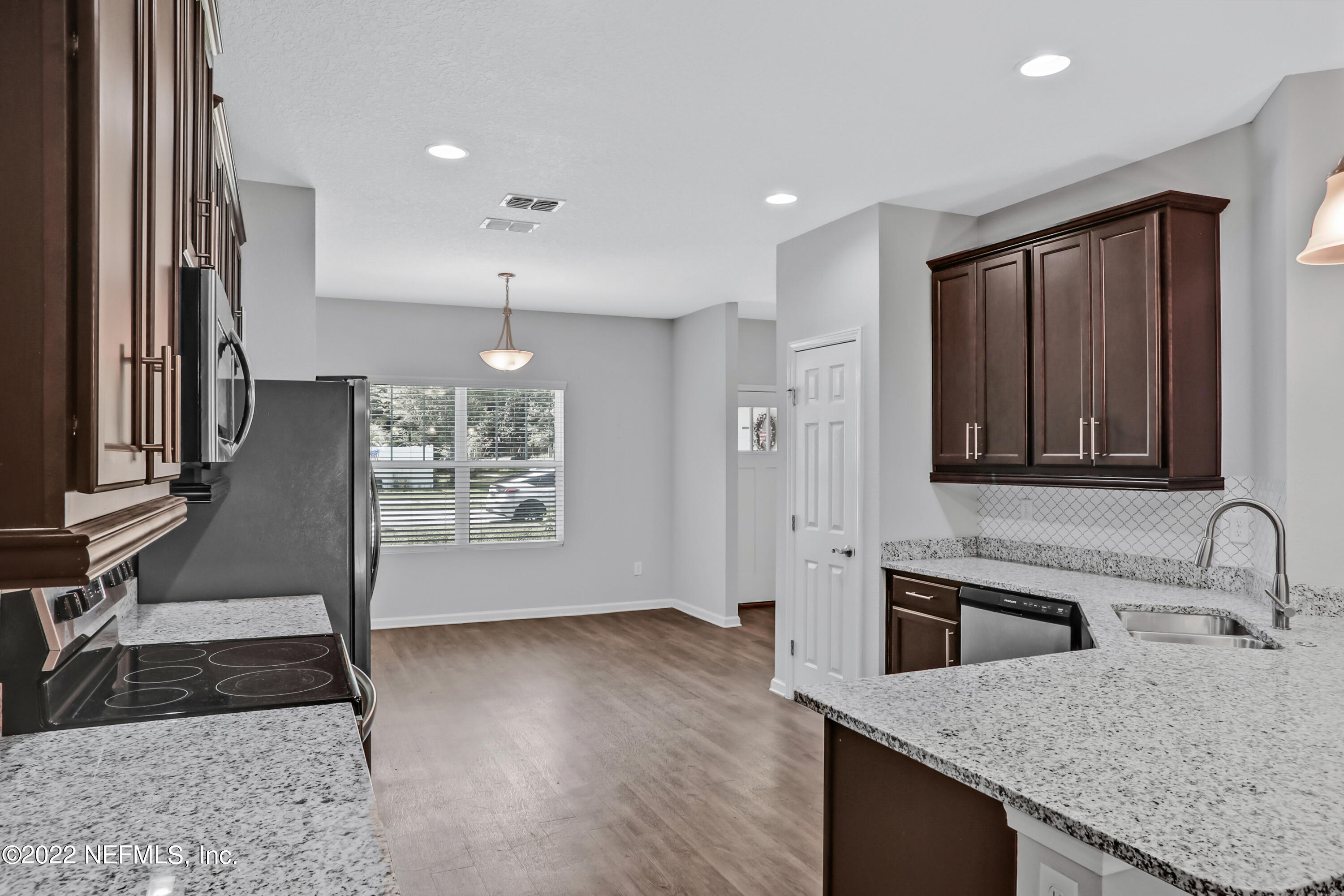 7507 Hilsdale Road Jacksonville, FL 32216 - Photo 9 of 38 a kitchen with granite countertop a sink a stove and cabinets