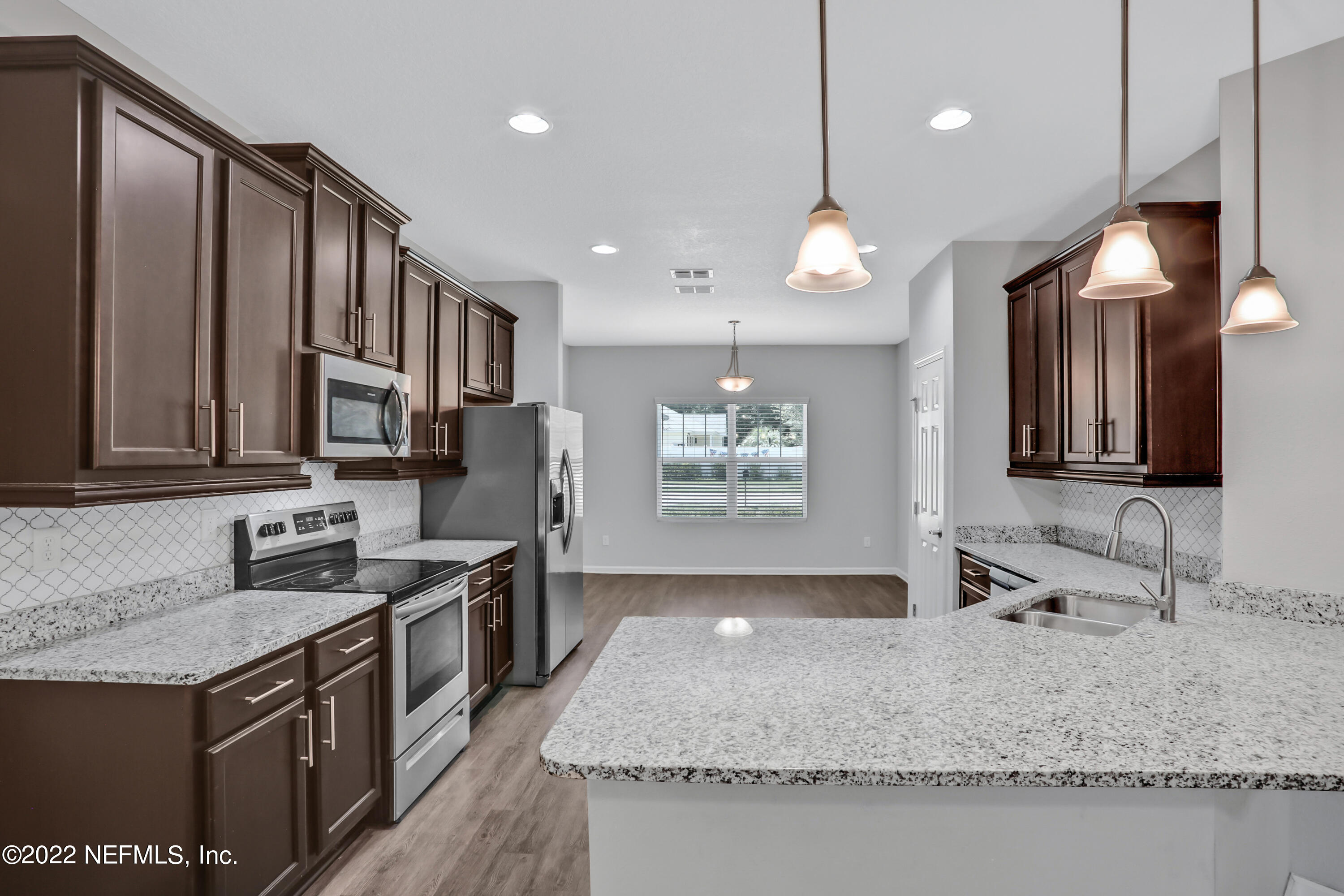 7507 Hilsdale Road Jacksonville, FL 32216 - Photo 10 of 38 a kitchen with stainless steel appliances granite countertop a sink stove and refrigerator