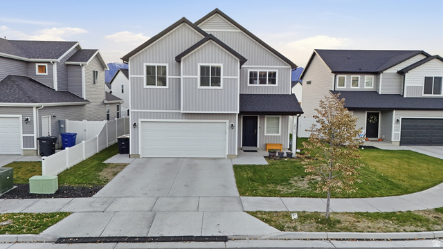 2011 Wren Circle Logan, UT 84339 - Photo 1 of 20 Traditional-style home featuring board and batten siding, an attached garage, and driveway