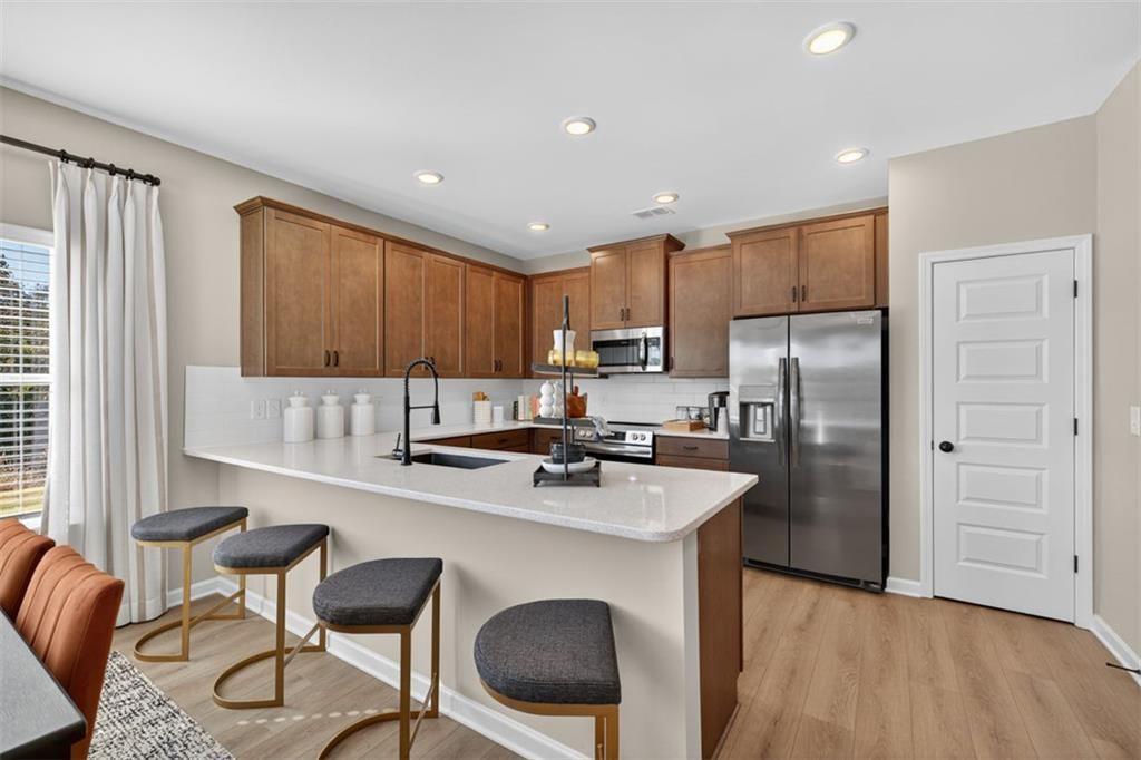 114 Andros Loop Dalton, GA 30721 - Photo 11 of 41 a kitchen with stainless steel appliances granite countertop a refrigerator a sink a stove a dining table and chairs