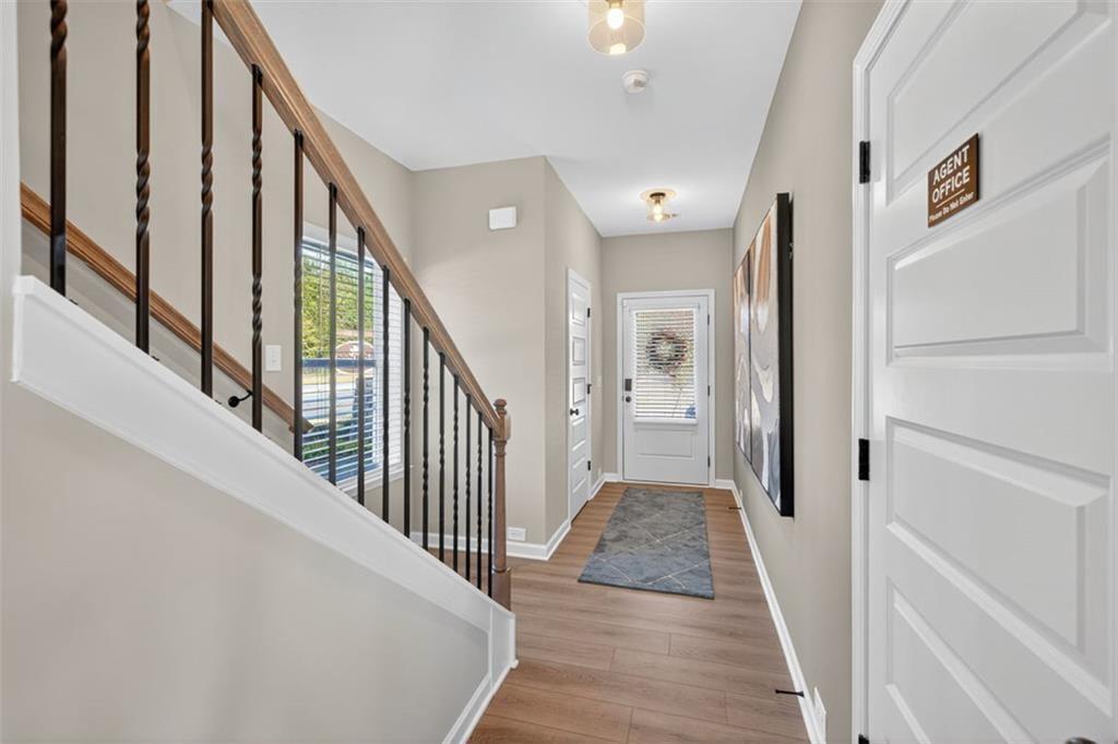 114 Andros Loop Dalton, GA 30721 - Photo 18 of 41 a view of a hallway with wooden floor and staircase