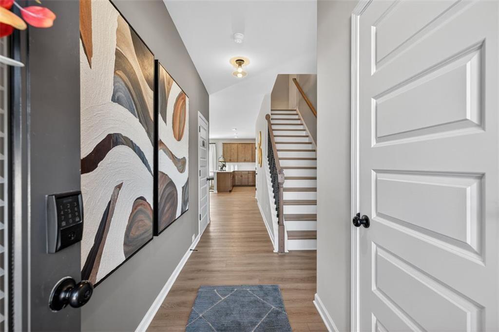 114 Andros Loop Dalton, GA 30721 - Photo 2 of 41 a view of a hallway with wooden floor and staircase