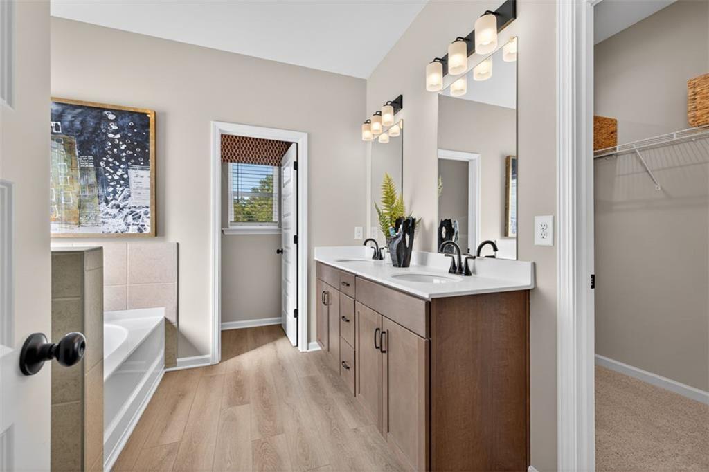 114 Andros Loop Dalton, GA 30721 - Photo 35 of 41 a bathroom with a sink a mirror a vanity and a shower