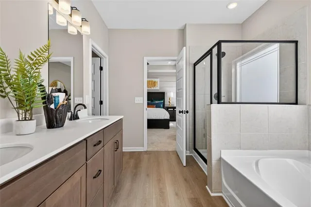 a bathroom with a tub sink and mirror