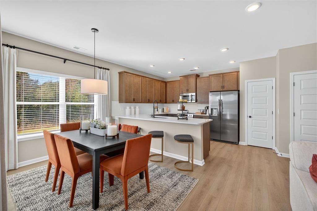 114 Andros Loop Dalton, GA 30721 - Photo 9 of 41 a kitchen with a dining table chairs and refrigerator