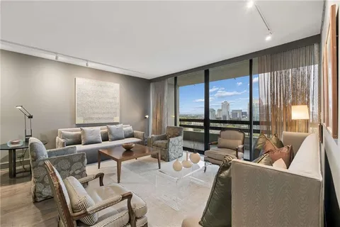 a living room with furniture and large windows