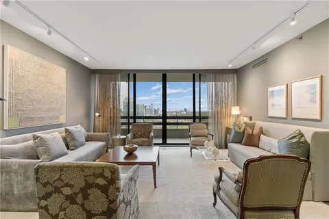 a living room with furniture and floor to ceiling window