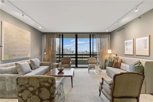 a living room with furniture and floor to ceiling window