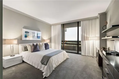 a spacious bedroom with a bed and a couch