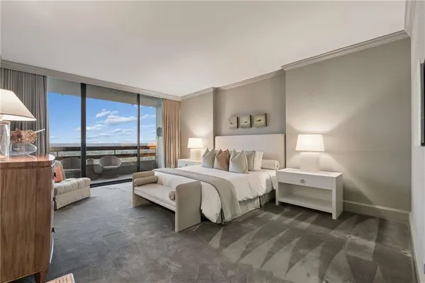 a spacious bedroom with a bed and large window