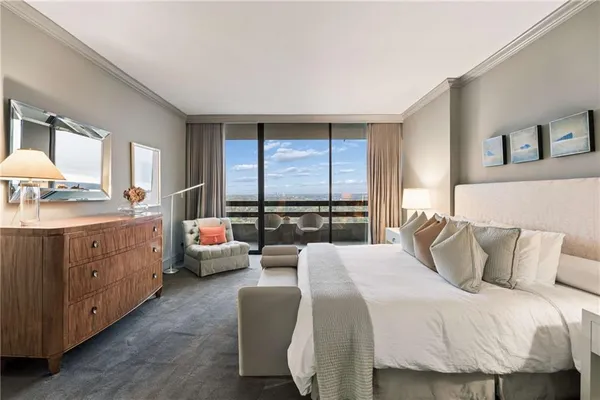 a bedroom with a large bed and a large window