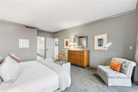 a bedroom with furniture and mirror