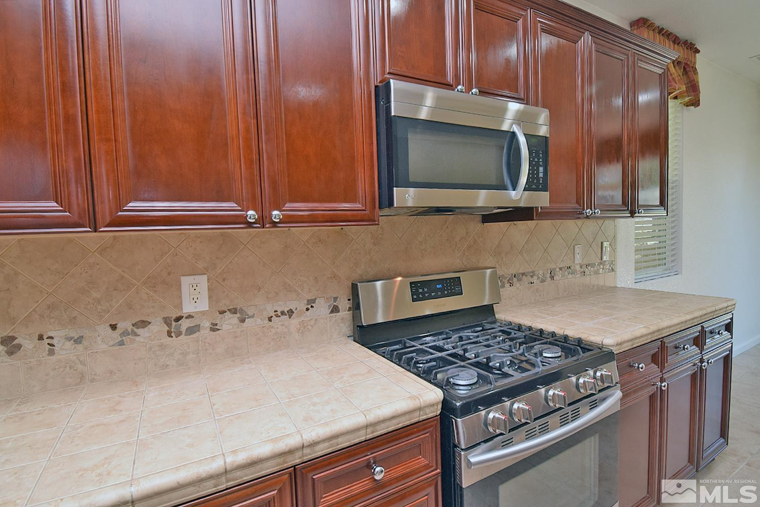 1955 Angel Ridge Drive Reno, NV 89521 - Photo 12 of 33 a kitchen with a stove and a microwave