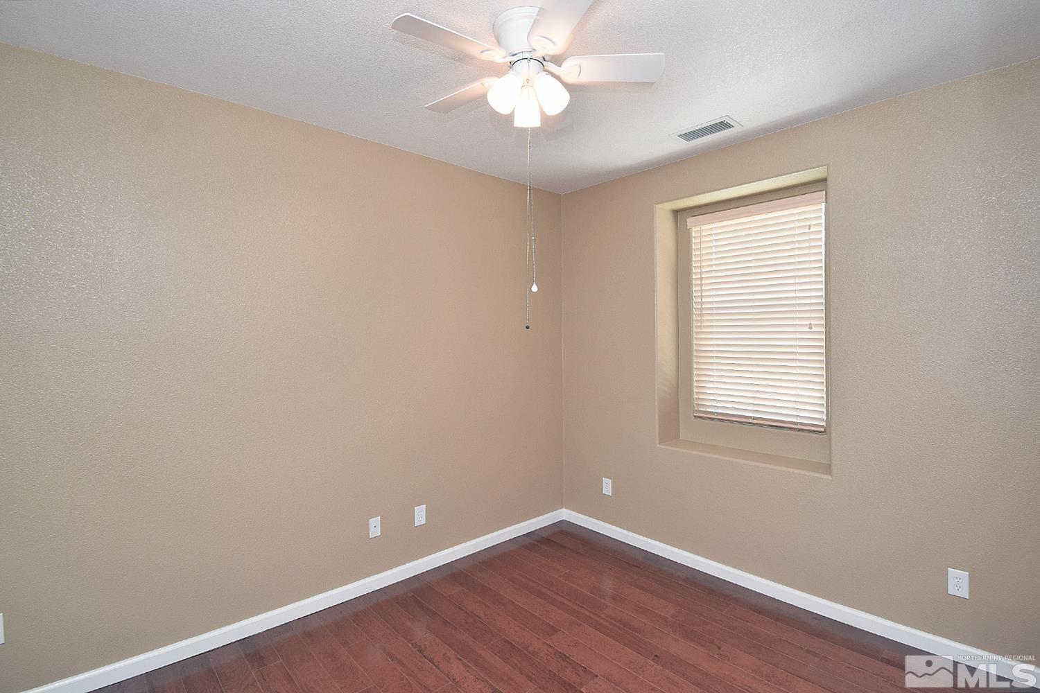 1955 Angel Ridge Drive Reno, NV 89521 - Photo 13 of 33 wooden floor in an empty room with a window
