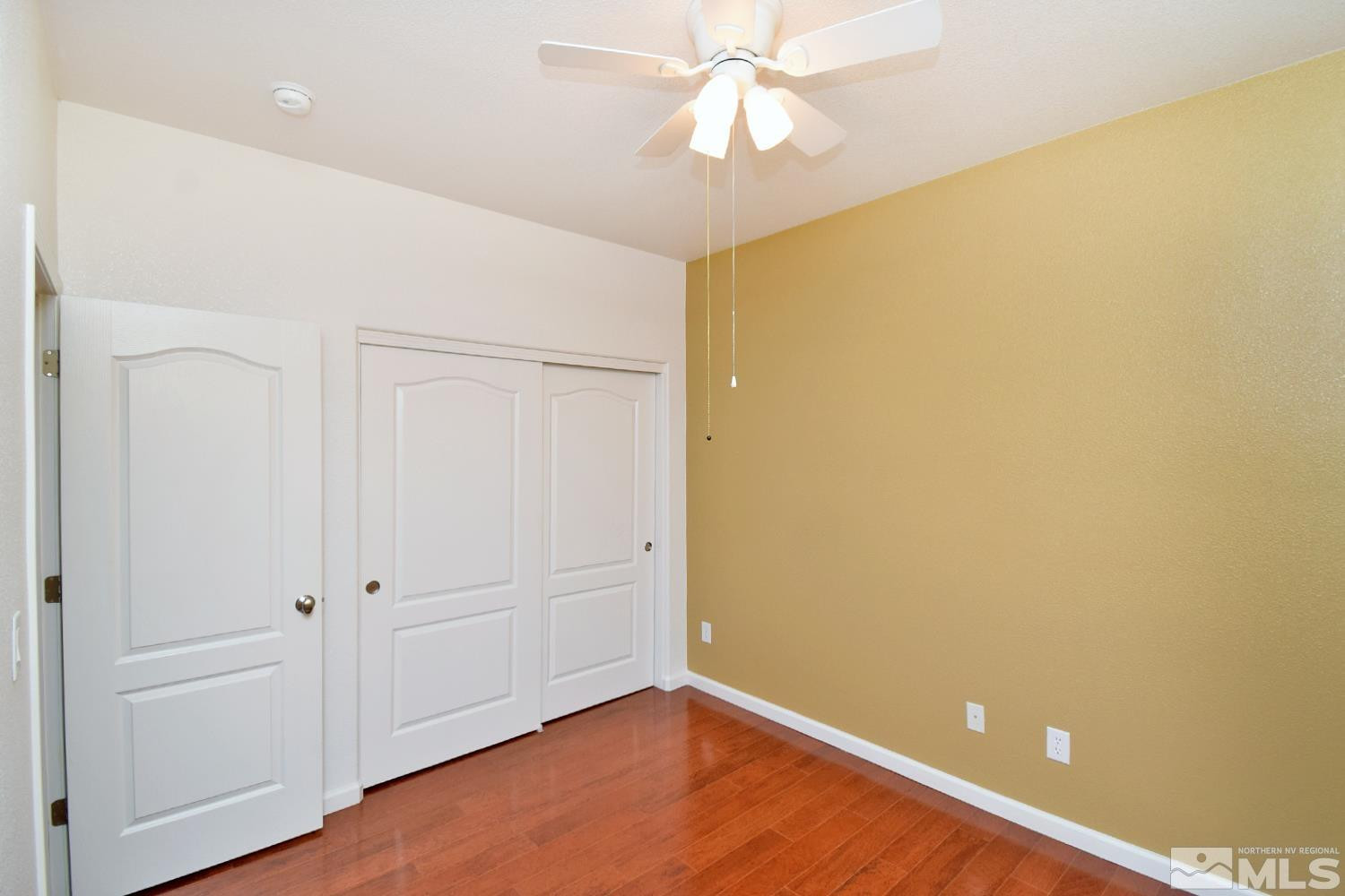 1955 Angel Ridge Drive Reno, NV 89521 - Photo 14 of 33 an empty room with wooden floor and closet area
