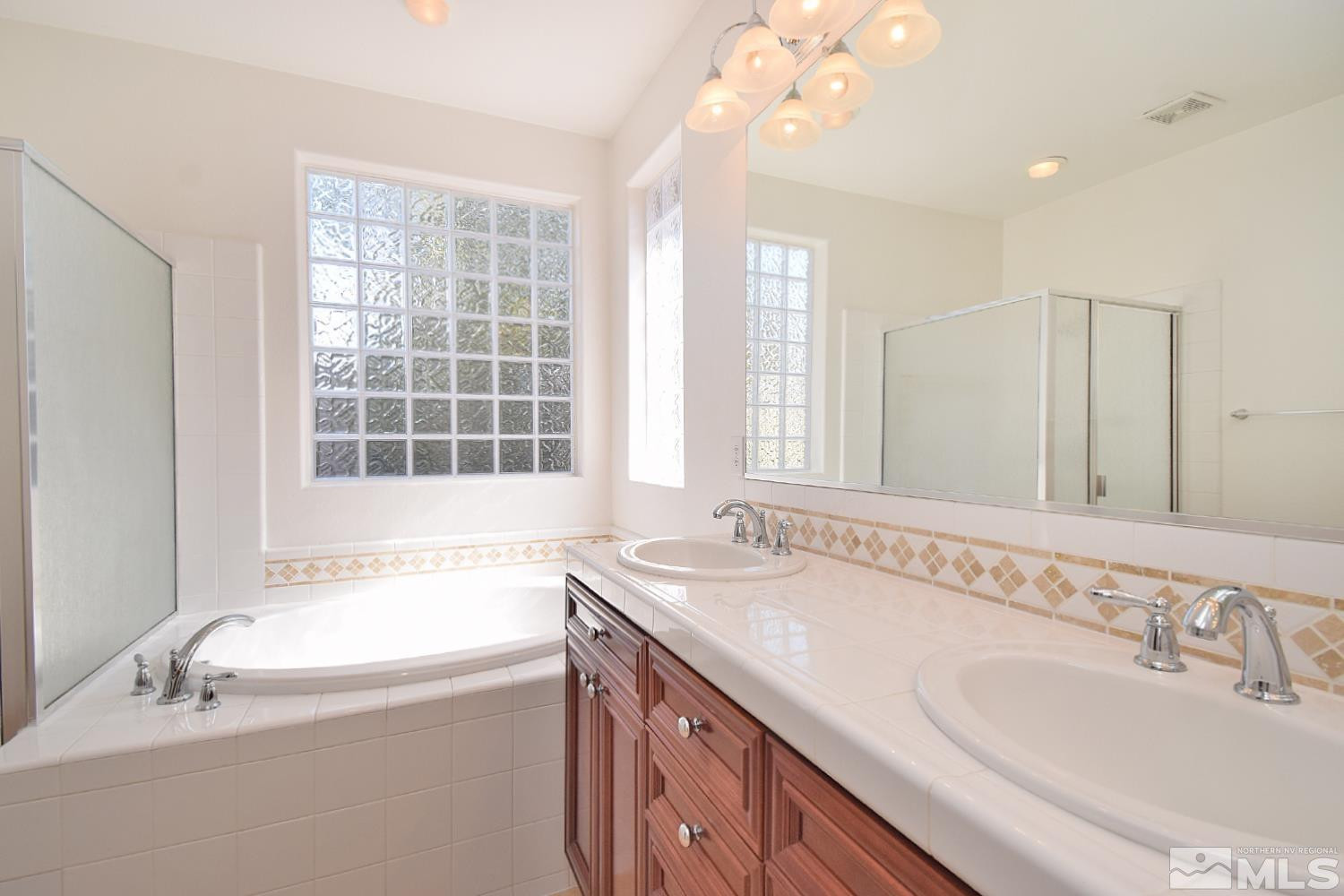 1955 Angel Ridge Drive Reno, NV 89521 - Photo 21 of 33 a bathroom with a granite countertop tub sink and mirror