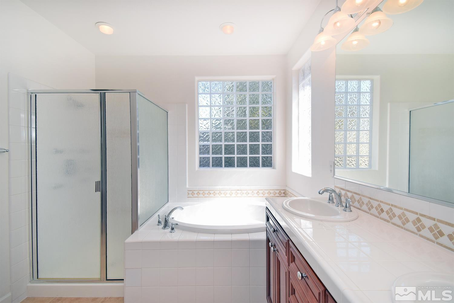 1955 Angel Ridge Drive Reno, NV 89521 - Photo 22 of 33 a bathroom with a granite countertop sink and a large mirror