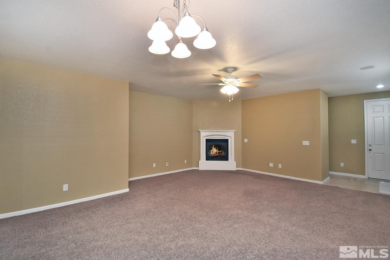 1955 Angel Ridge Drive Reno, NV 89521 - Photo 4 of 33 a view of an empty room with a chandelier fan