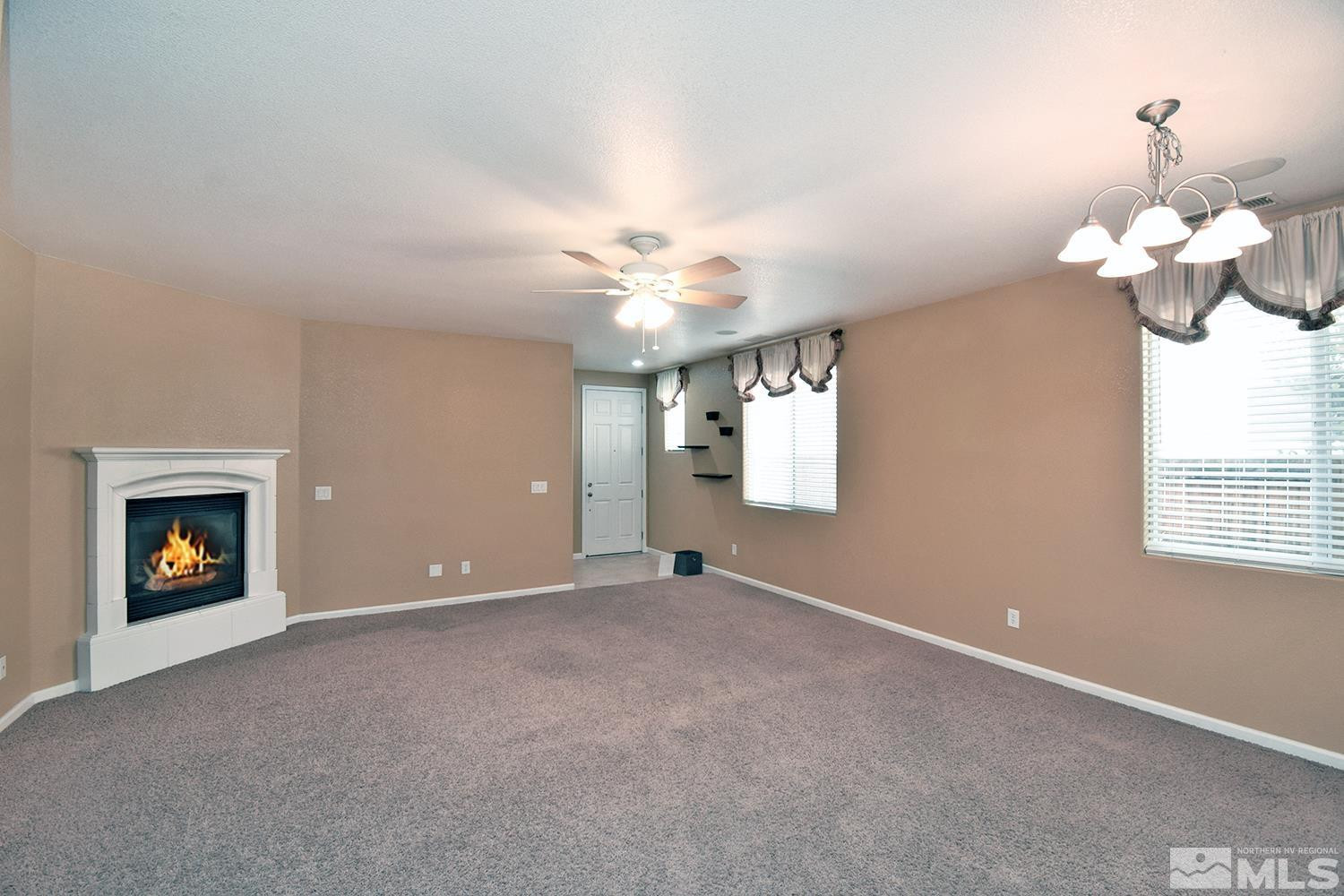 1955 Angel Ridge Drive Reno, NV 89521 - Photo 5 of 33 a view of an empty room with window and fireplace
