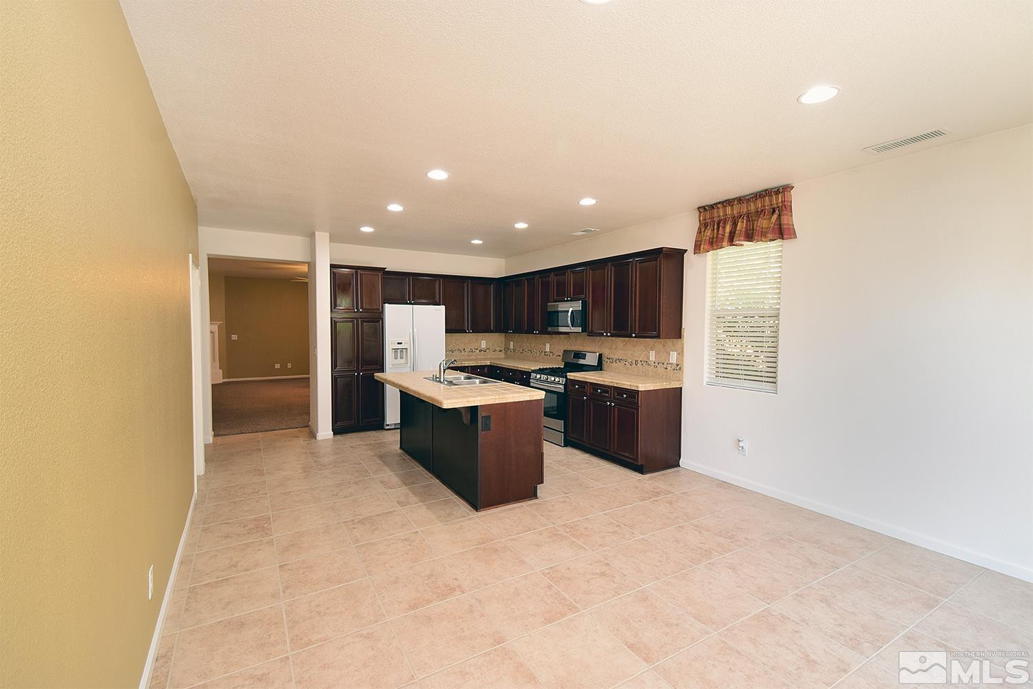 1955 Angel Ridge Drive Reno, NV 89521 - Photo 8 of 33 a kitchen with a refrigerator and a sink