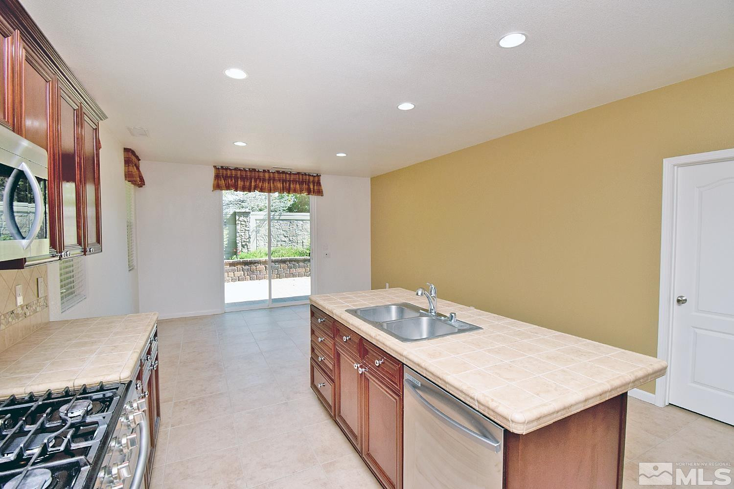 1955 Angel Ridge Drive Reno, NV 89521 - Photo 9 of 33 a kitchen that has a sink a stove and a table in it
