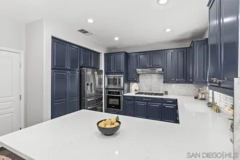 a kitchen with stainless steel appliances a refrigerator and a stove