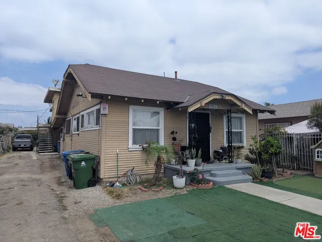 a view of a house with backyard and sitting area