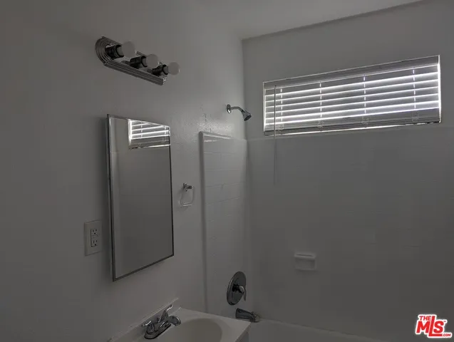 a bathroom with a bathtub and shower