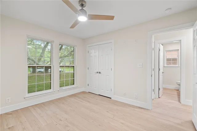 an empty room with windows and closet