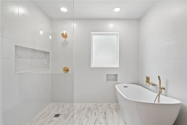 a bathroom with a bathtub and shower