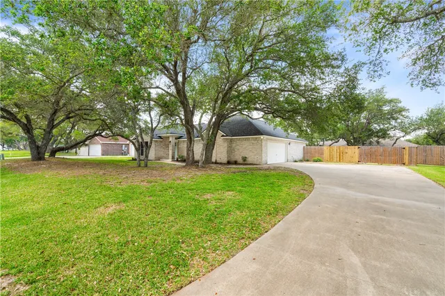 a front view of house with yard and trees