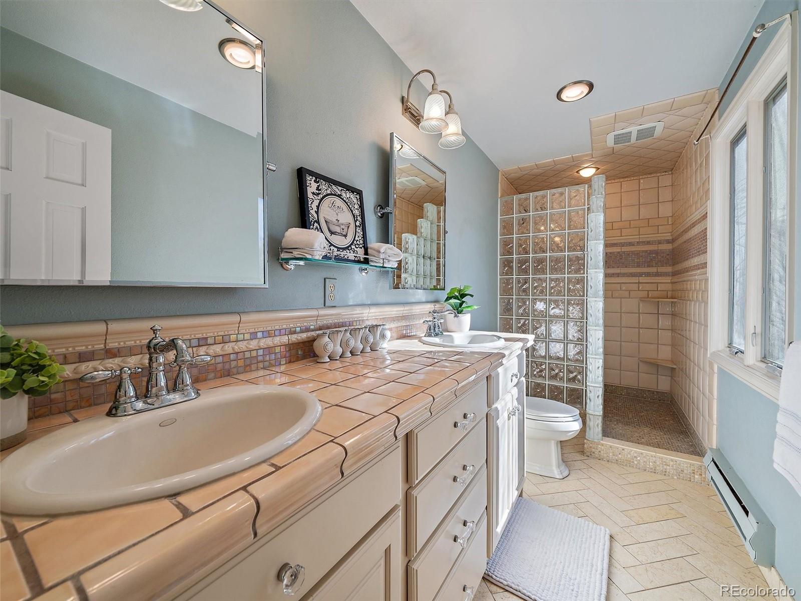 33913 Upper Bear Creek Road Evergreen, CO 80439 - Photo 24 of 45 a bathroom with a double vanity sink mirror and toilet
