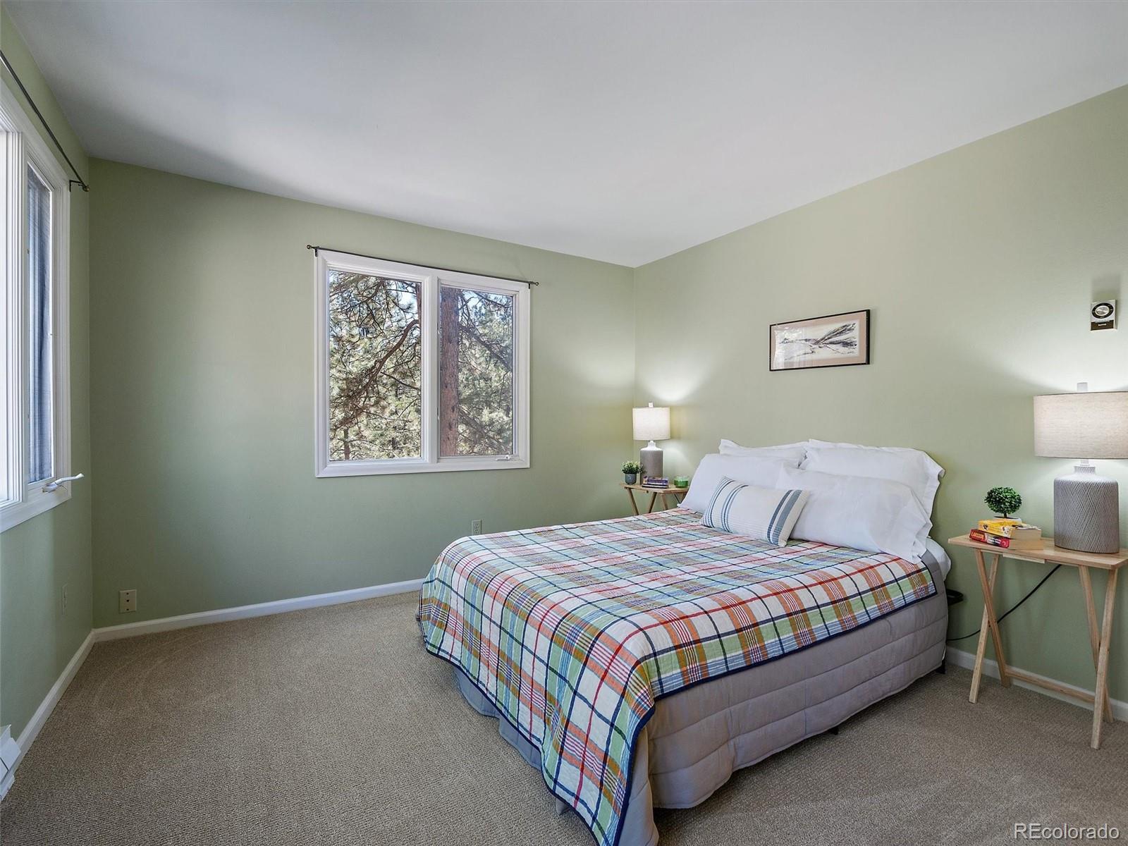33913 Upper Bear Creek Road Evergreen, CO 80439 - Photo 29 of 45 a bedroom with a bed lamp and window