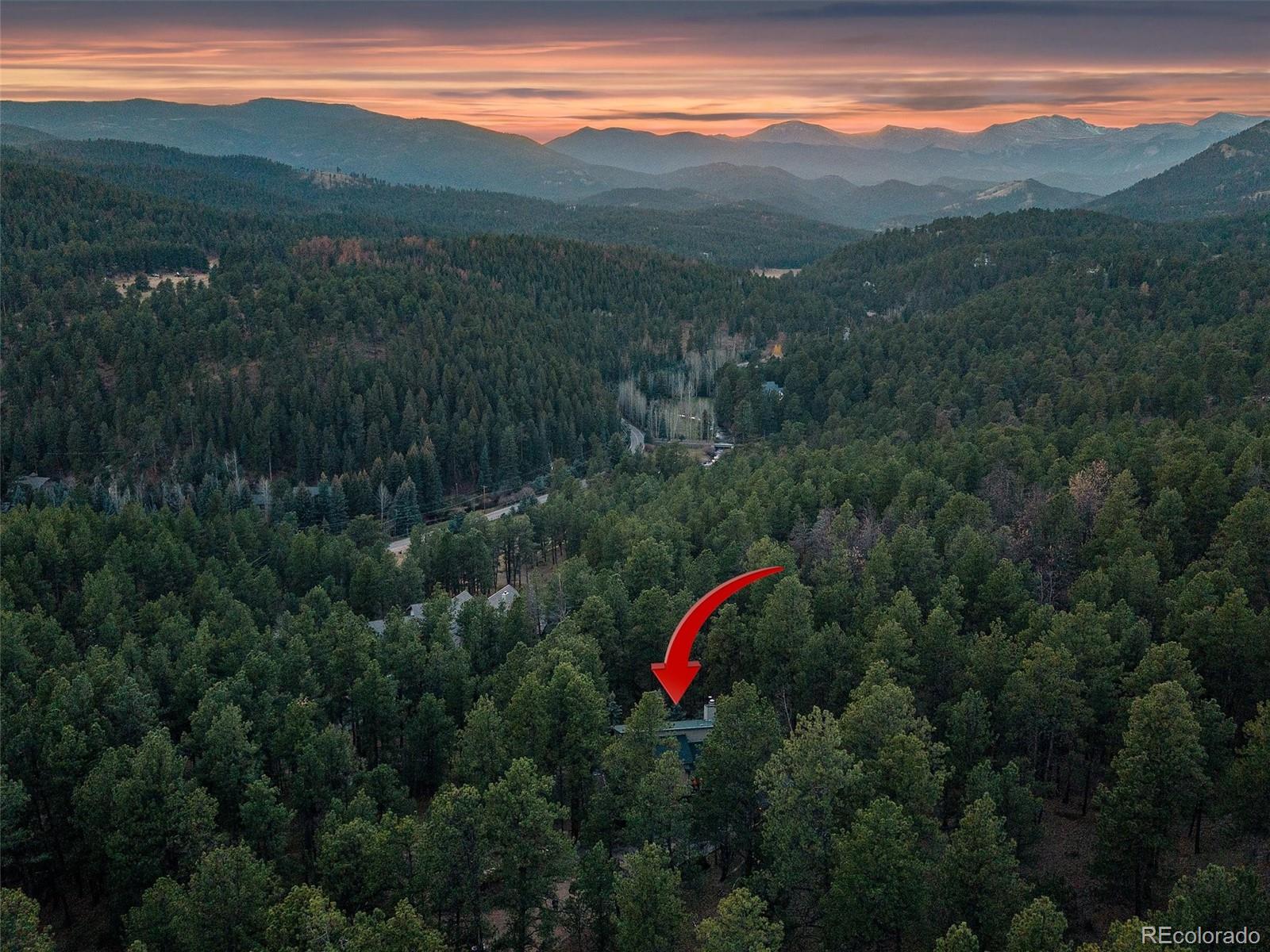 33913 Upper Bear Creek Road Evergreen, CO 80439 - Photo 42 of 45 a view of a mountain with an outdoor space