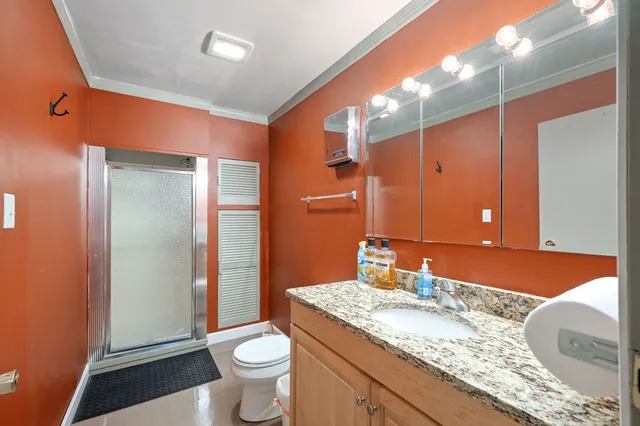 a white toilet sitting next to a bathroom sink