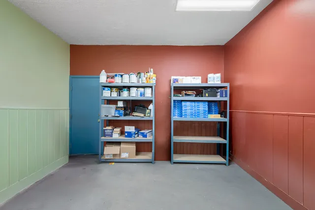 a kitchen with kitchen island granite countertop a sink a counter space appliances and cabinets