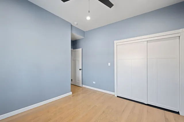 a bathroom with a toilet a sink a mirror and a shower