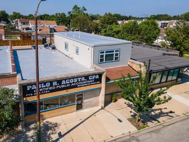 an aerial view of a city with lots of residential buildings and parking space