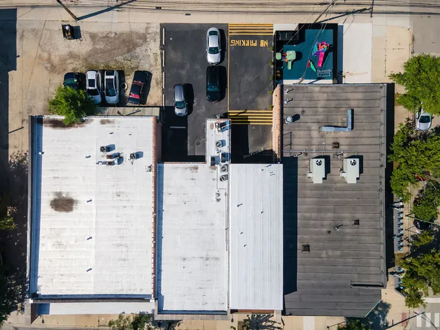 a view of a cars park in front of a building