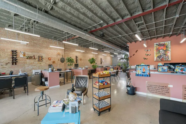 a living room with lots of furniture and a refrigerator