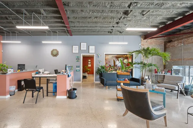 a work room with furniture and a flat screen tv