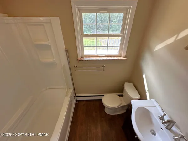 a white toilet sitting next to a window