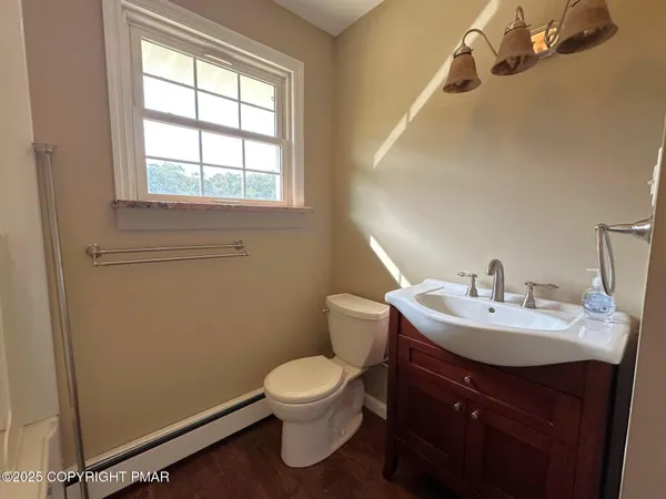 a bathroom with a sink vanity mirror and toilet