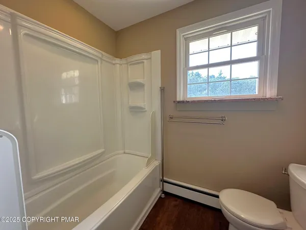 a bathroom with a toilet and a bathtub