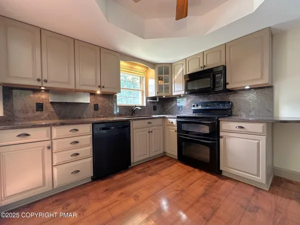 a kitchen with stainless steel appliances white cabinets and a sink